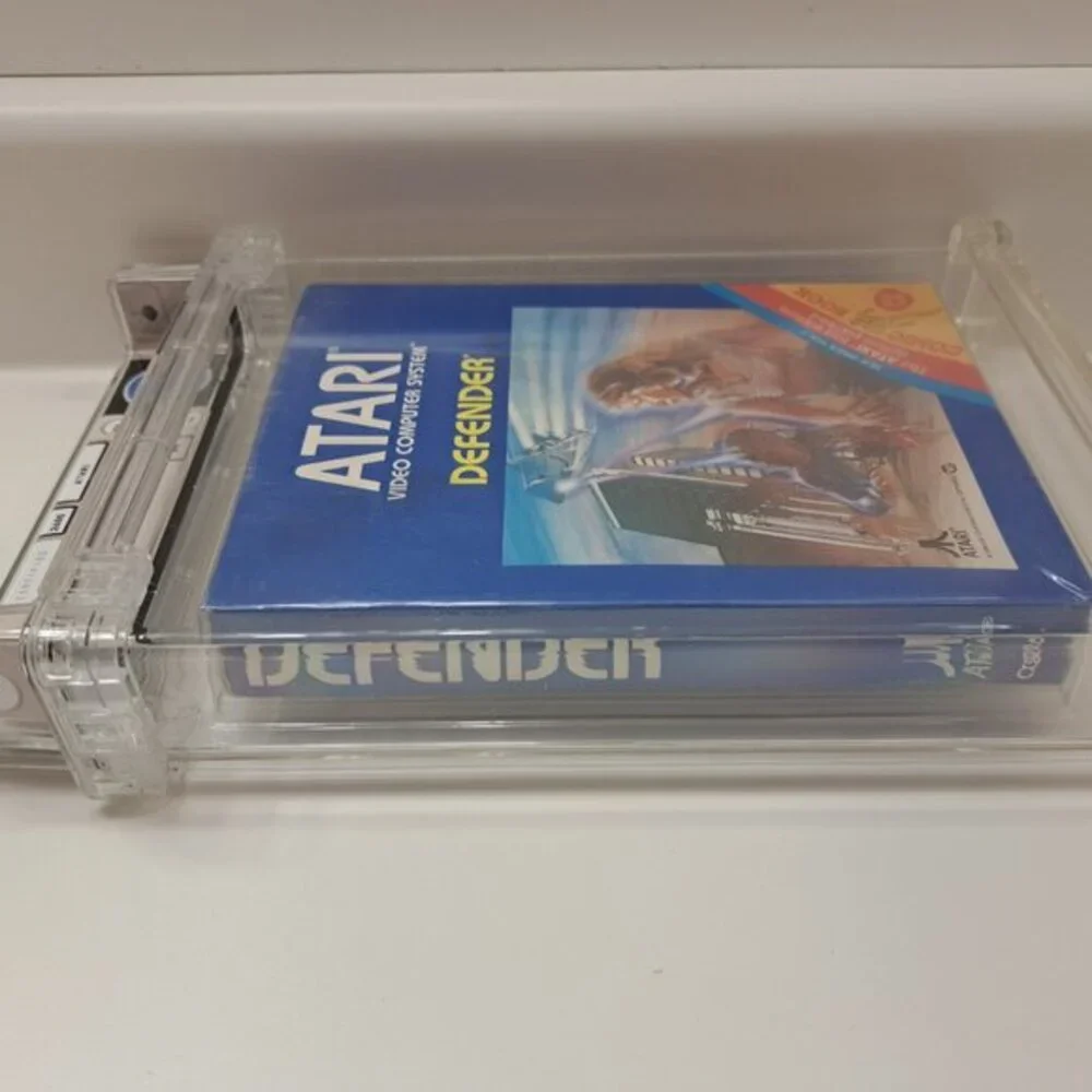 Atari 2600 DEFENDER - EARLY HANGTAB BLUE BOX! WATA GRADED 5.5! NEW & UNOPENED!